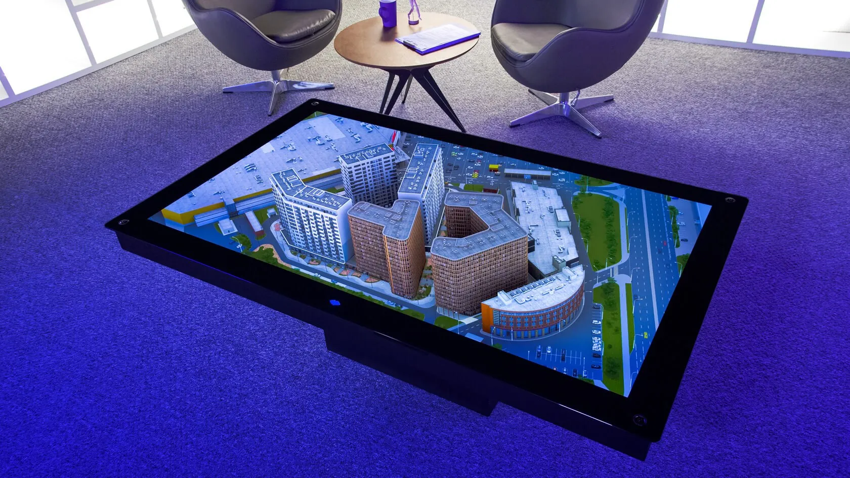 A 3D building model appearing to stand on the ILLUMETRY EOS hologram table