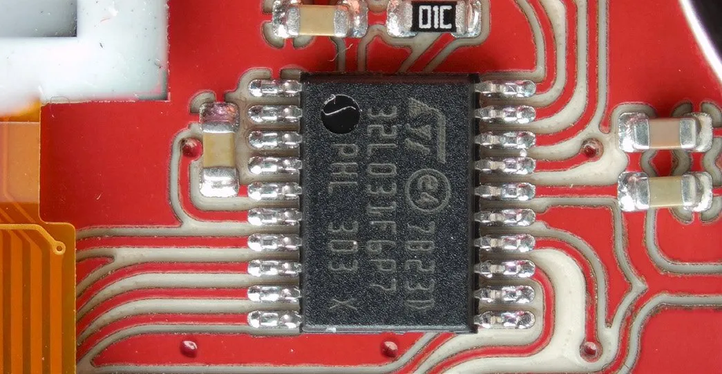 Close-up of a fine-pitch IC soldered on a PewCB board