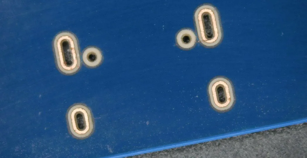 Plated through-holes on the bottom side of a PCB blank
